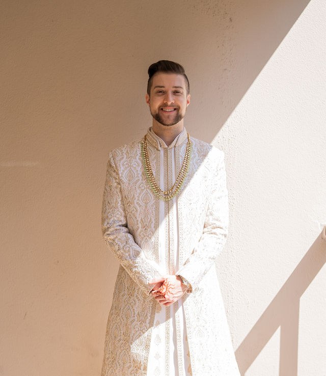 Caden dressed for the wedding in warm window light