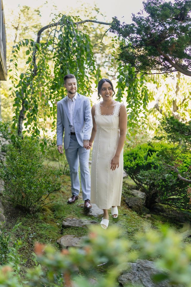 Anika and Caden beneath leafy trees in their pre-wedding portraits