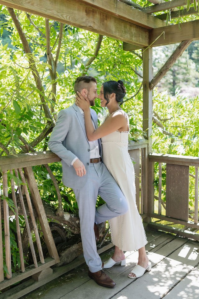 Anika and Caden together beneath the wooden arbor