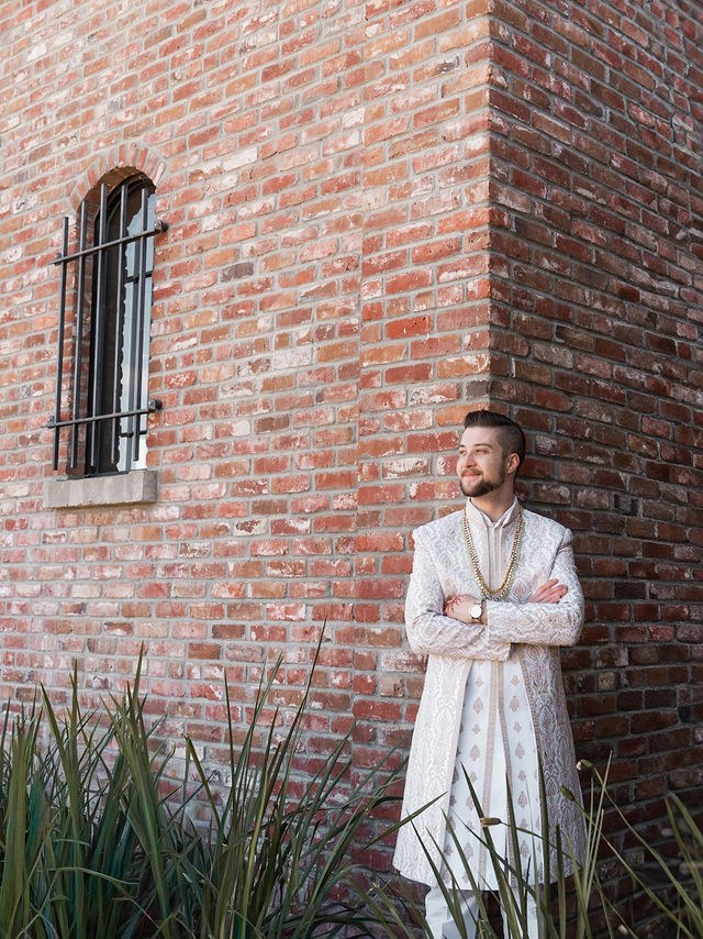 Caden standing beside the brick courtyard