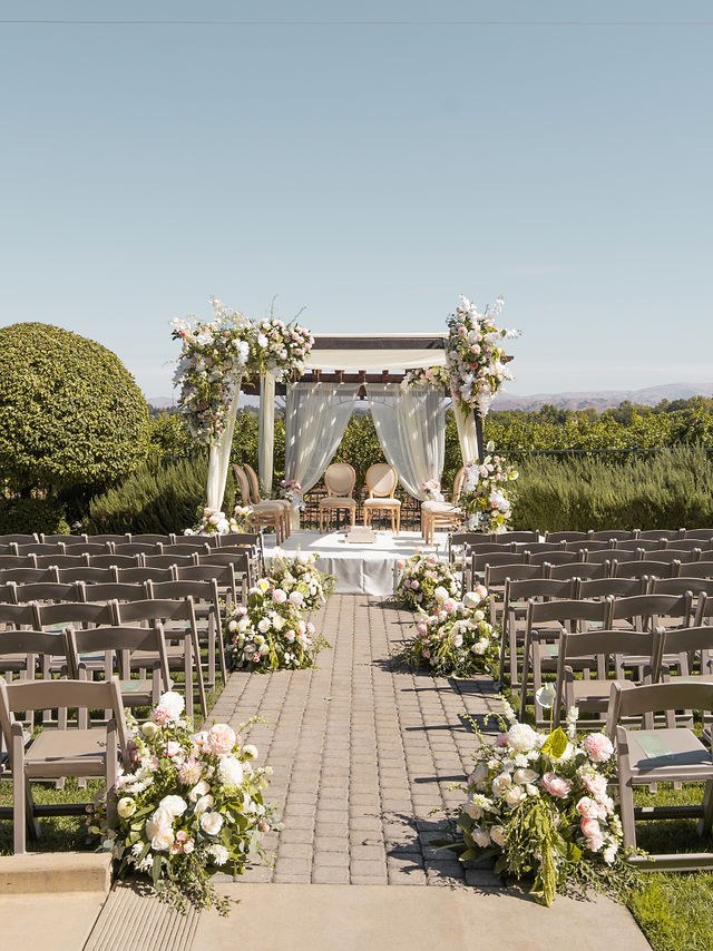 The flower-framed outdoor wedding ceremony setting
