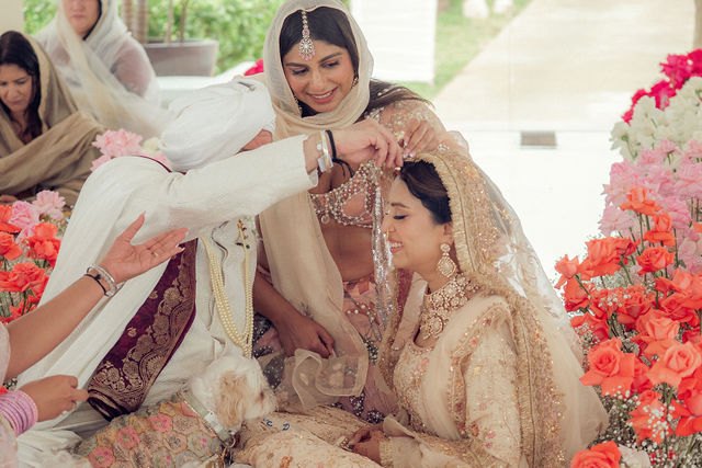 A family elder blessing Aisha during the ceremony