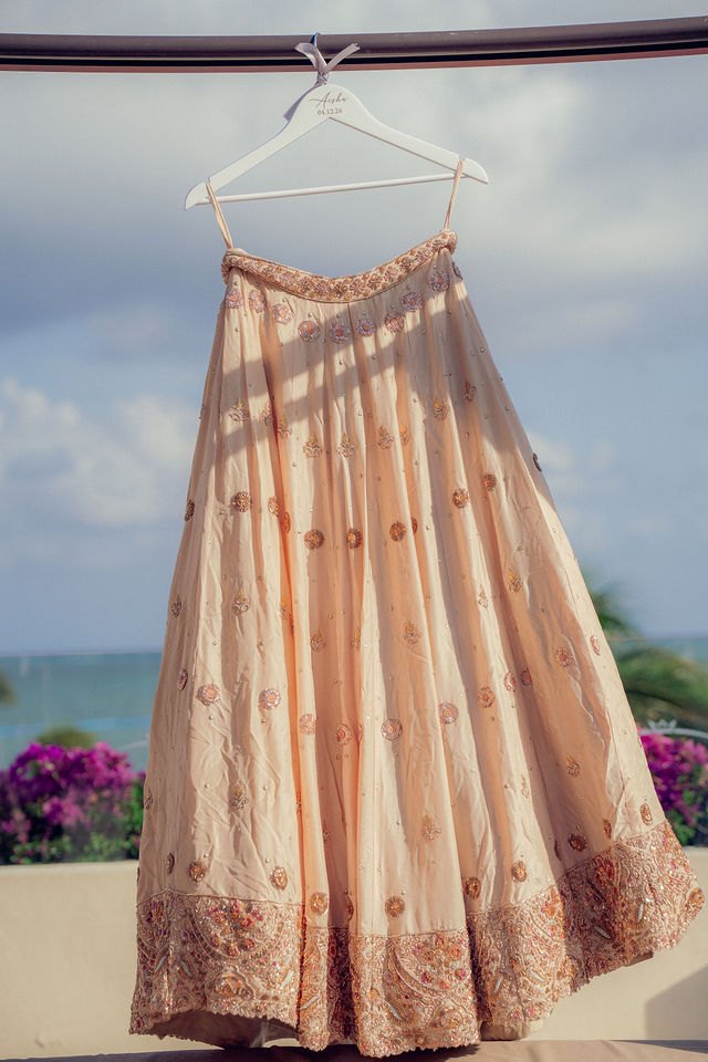 Aisha’s embroidered wedding outfit against the coastal sky