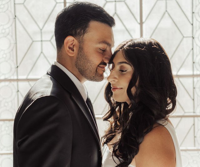 Alisha and Sean in a close portrait by patterned glass