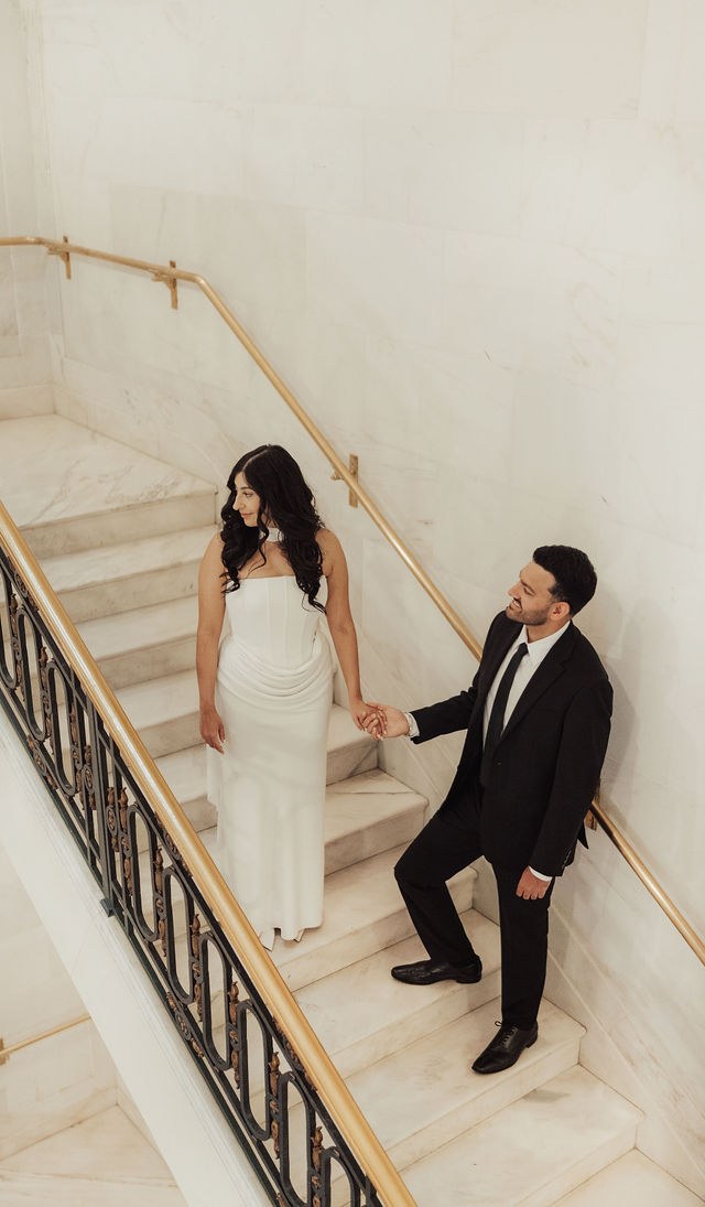 Alisha and Sean on a sweeping stone staircase
