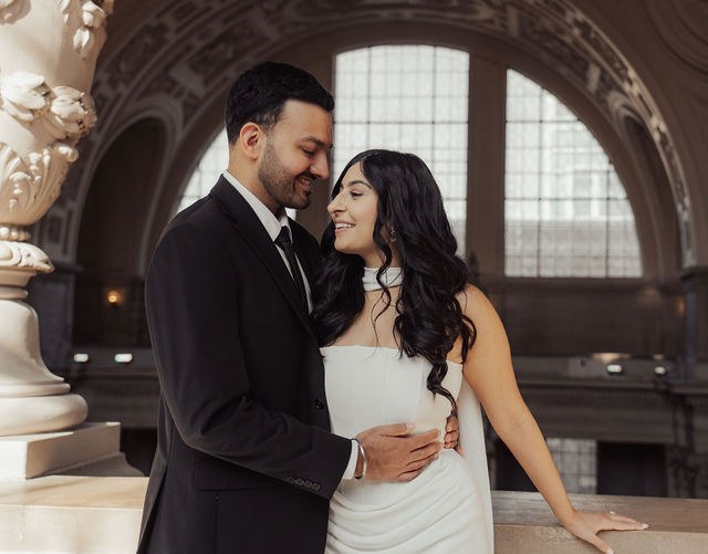 Alisha and Sean together beneath a grand stone arch