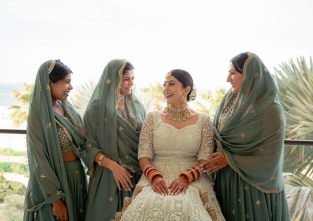 Alisha with loved ones in sage-toned wedding attire