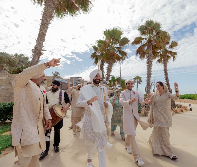 The wedding party celebrating among palms and ocean views