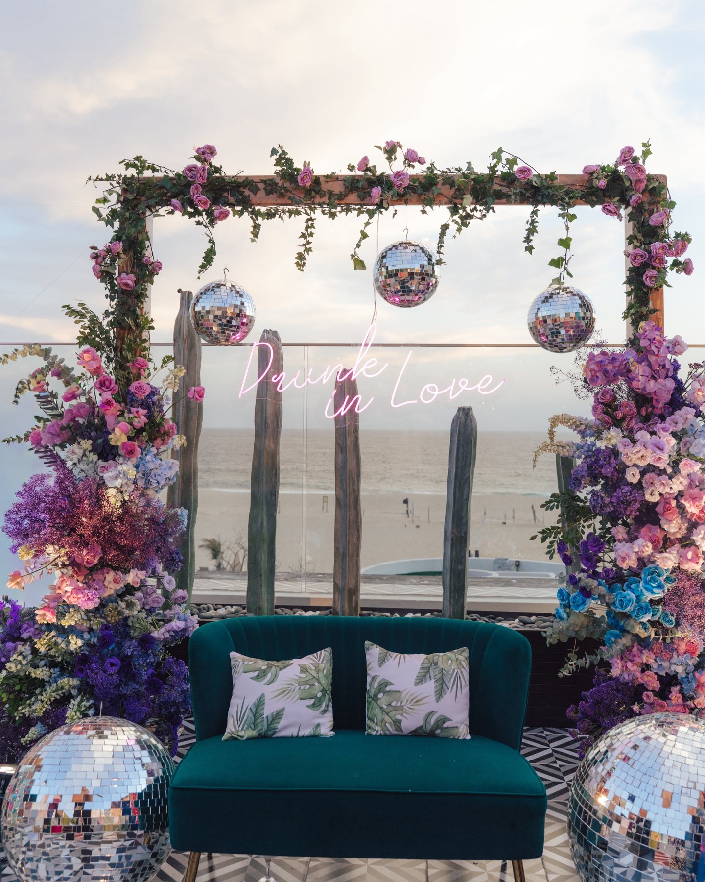 Vibrant floral installation and mirrored details above the Cabo coast