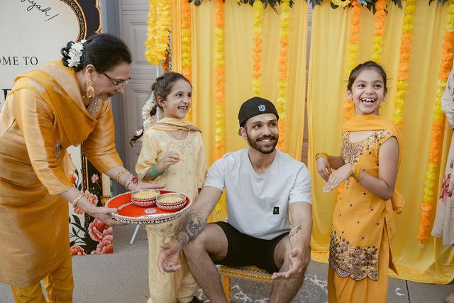 Family sharing a playful Haldi moment with Yugraj