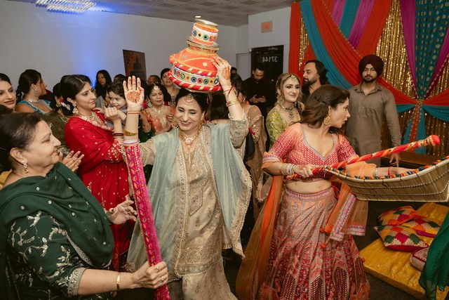 Women celebrating with a decorated vessel at the Jaggo