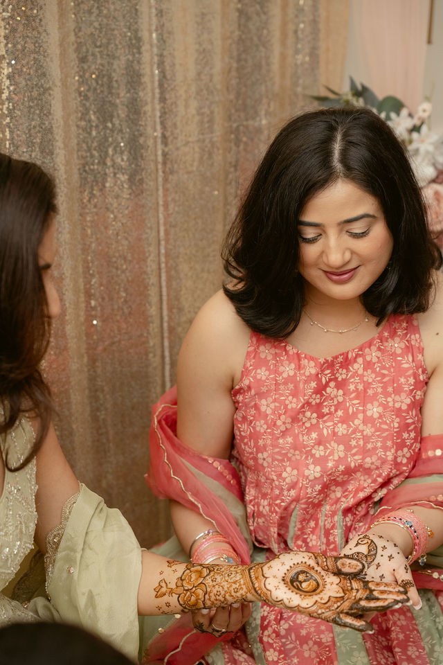 Banpreet looking at the henna on her hands