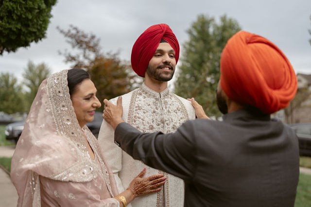 Yugraj receiving a final adjustment to his wedding attire