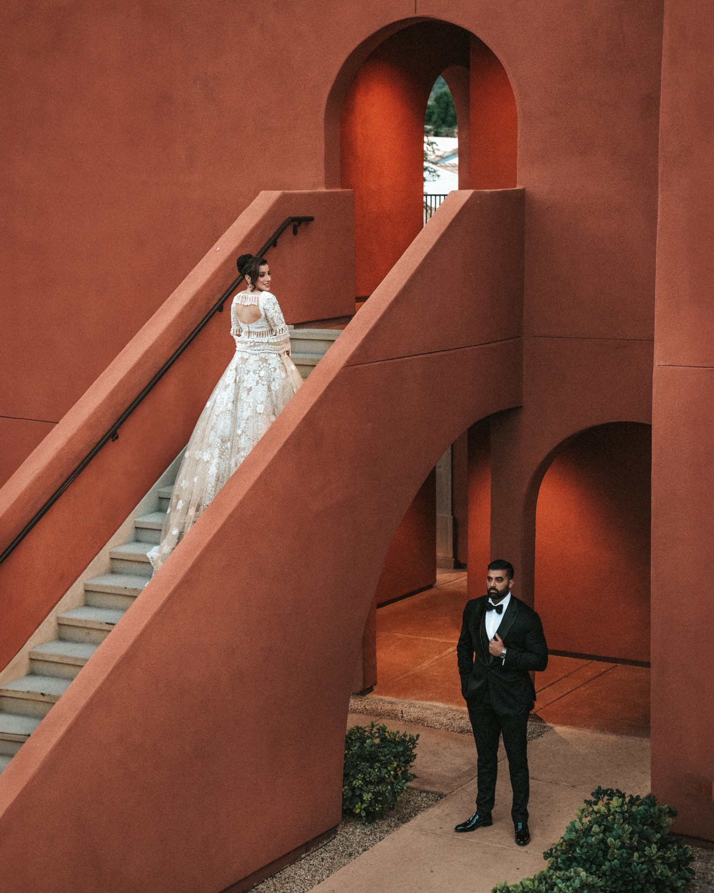Jessey and Aman in a terracotta architectural wedding portrait