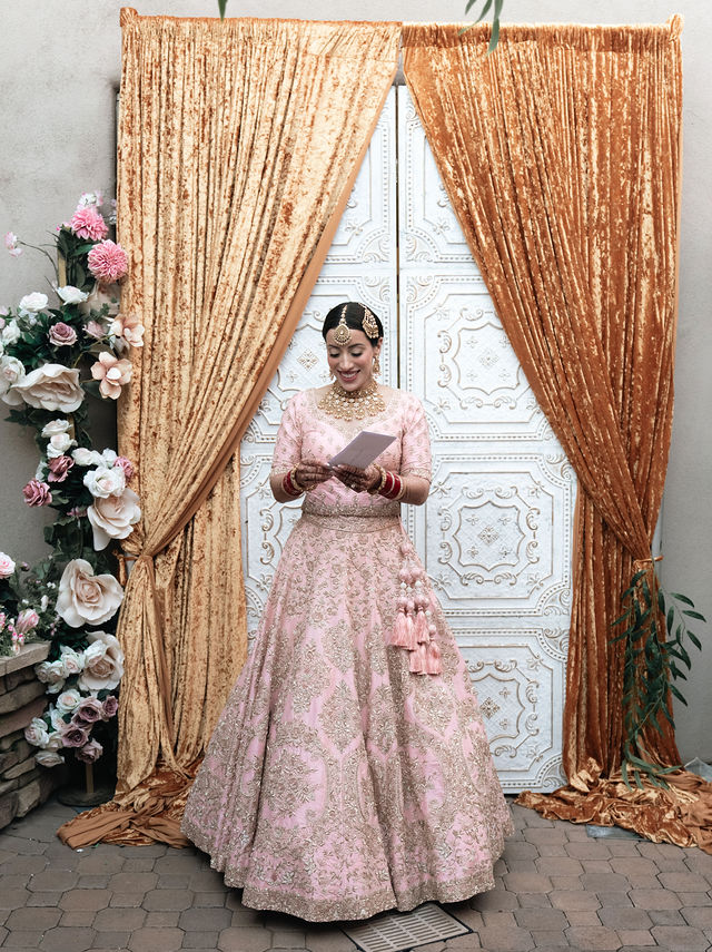 Aman framed by gold drapery