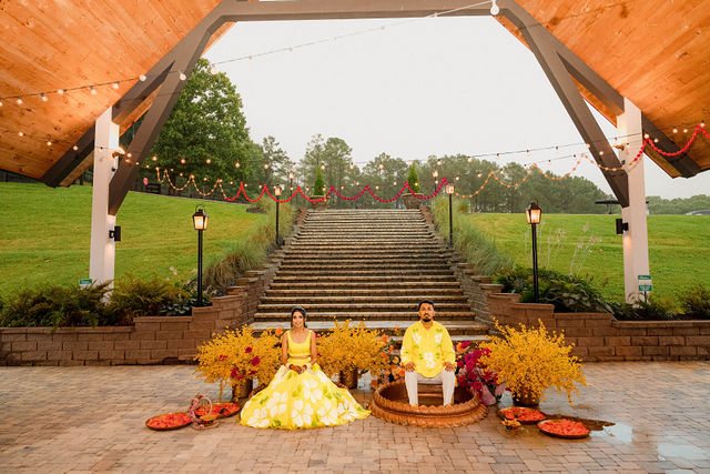 Yellow flowers and two ceremonial seats beneath the timber pavilion