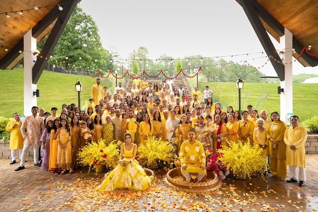Family and friends in yellow gathered beneath the pavilion