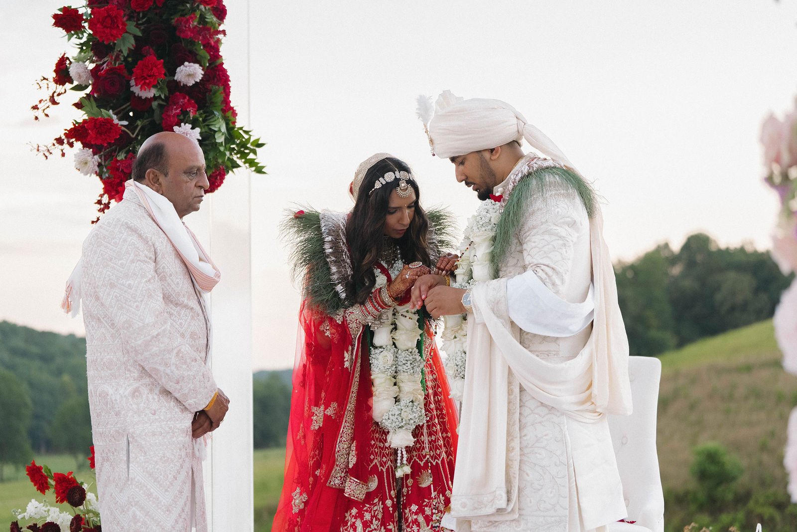Khyati and Bishal share a wedding ritual with family beside them