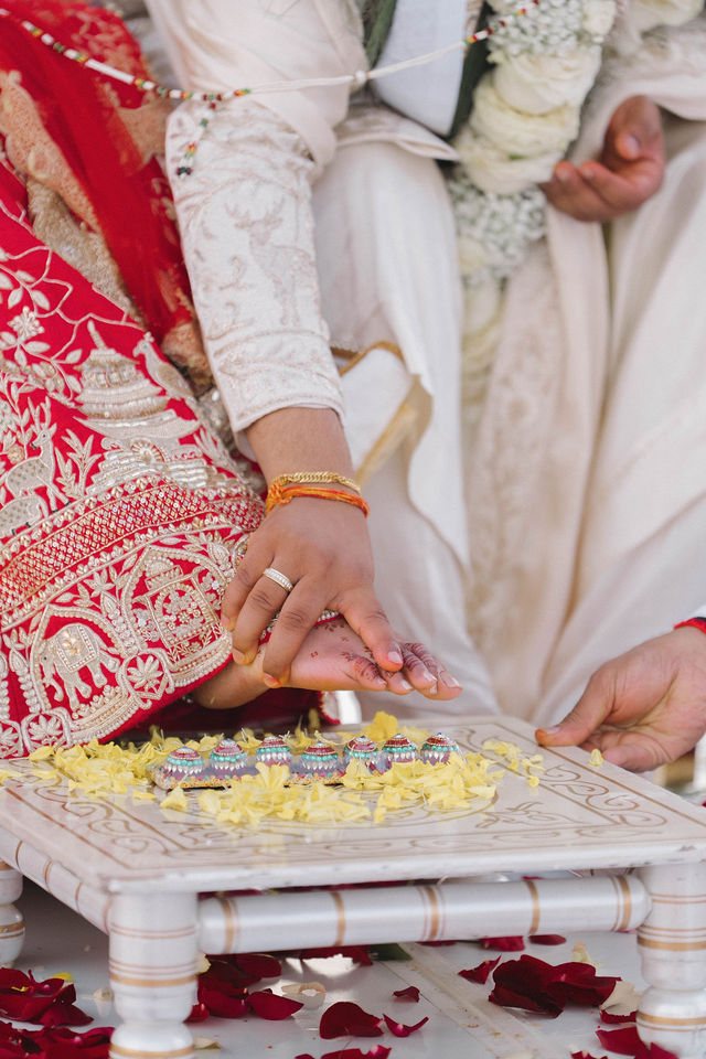 Khyati and Bishal’s hands meet during a wedding ritual