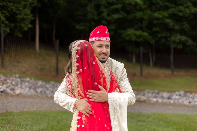 Khyati and Bishal embracing in the grounds of Swan Lake Overlook