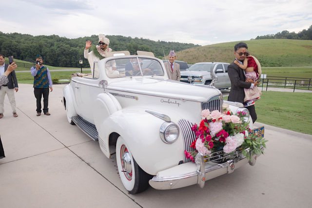 A flower-adorned white vintage car at Khyati and Bishal’s wedding