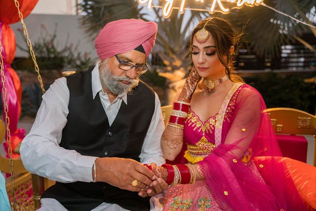 Grace and a family elder sharing a wedding ritual