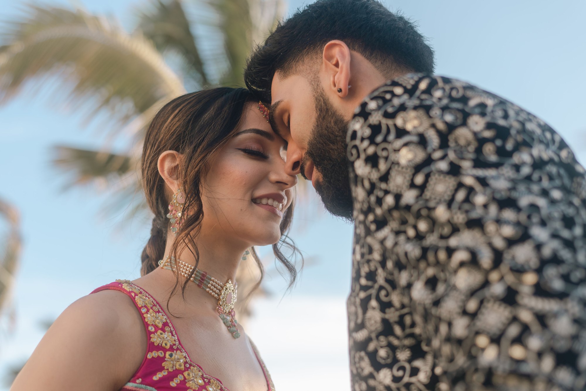 Grace and Karan leaning together in Los Cabos
