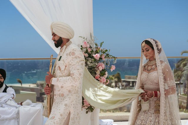 Grace and Karan connected by the palla during their Anand Karaj