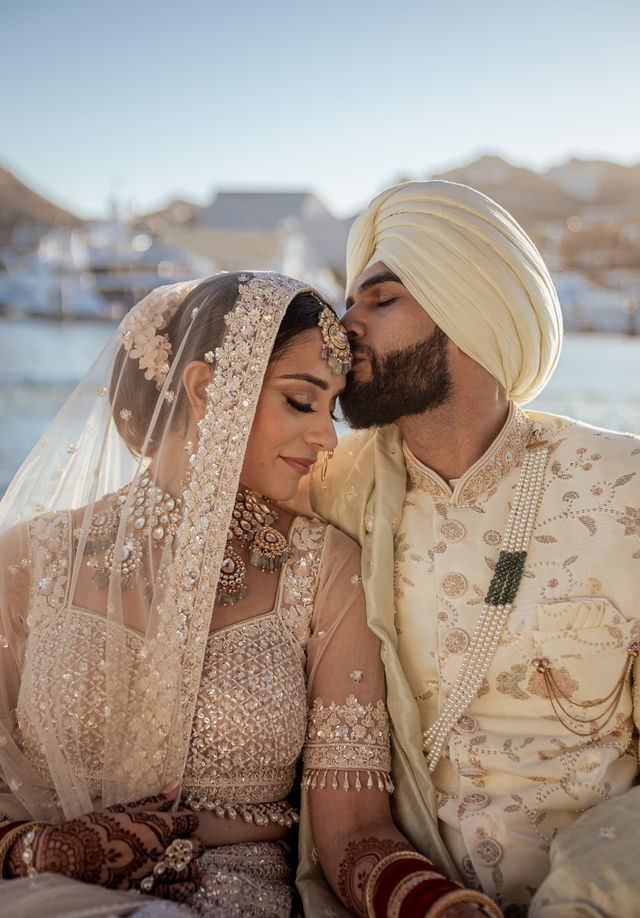 Grace and Karan in their wedding attire beside the Los Cabos coast