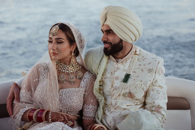 Grace and Karan seated together on a yacht off Los Cabos