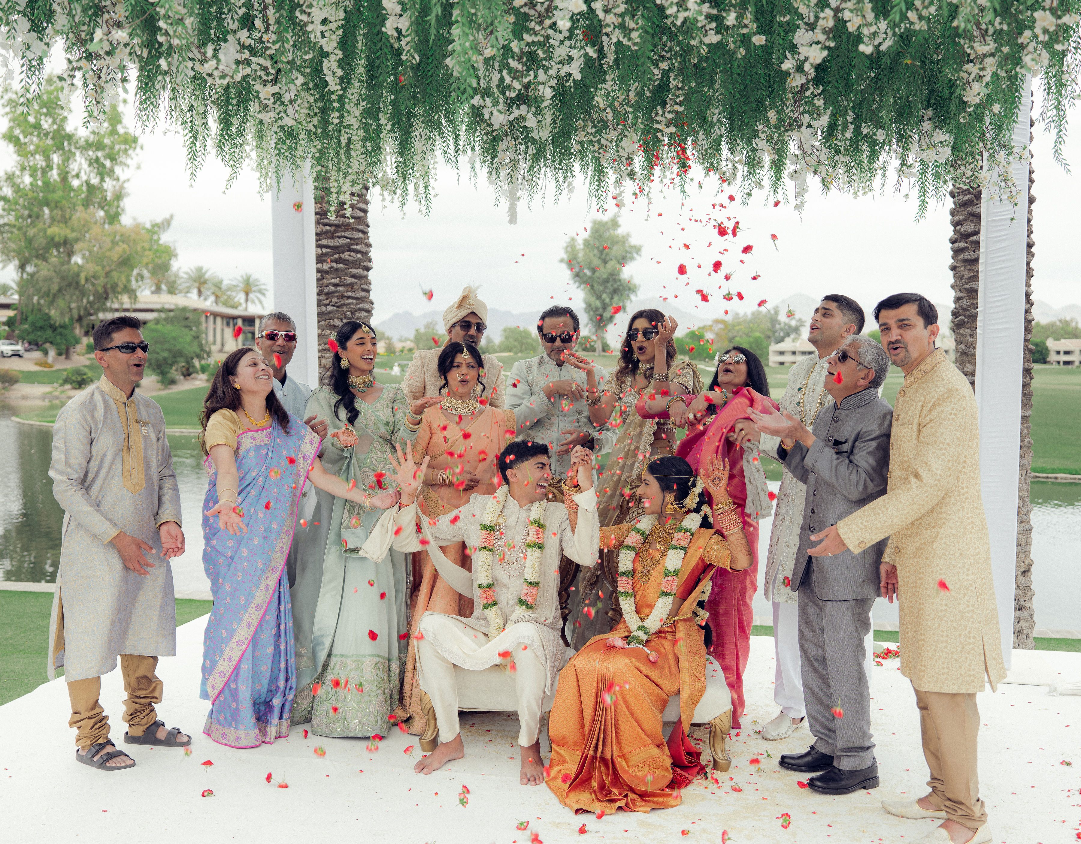 Family gathers around Karishma and Shil as rose petals fall