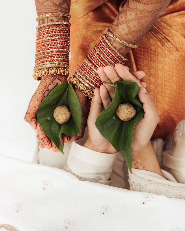 A close photograph of the couple’s hands during the ceremony