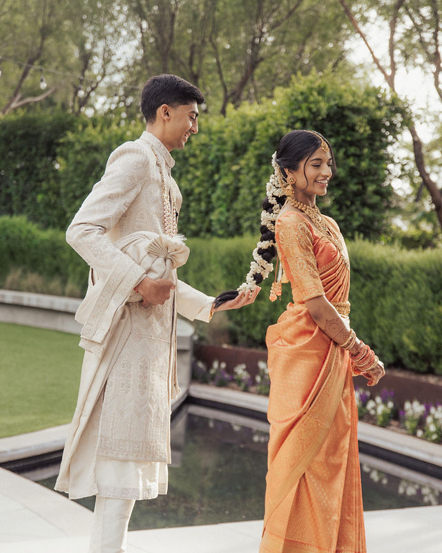 Karishma and Shil turn toward each other on a garden bridge