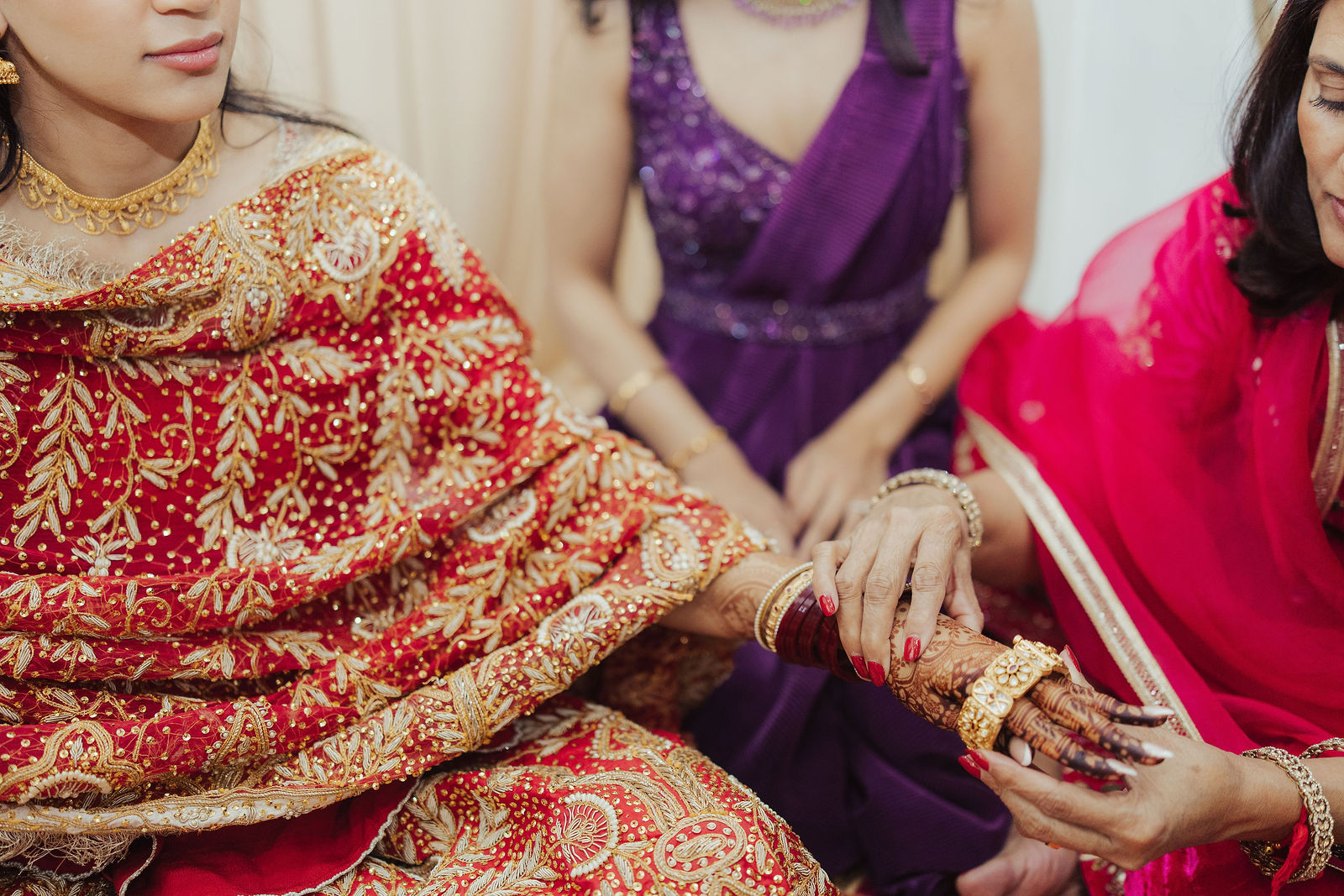 Family hands taking part in the bangle ceremony