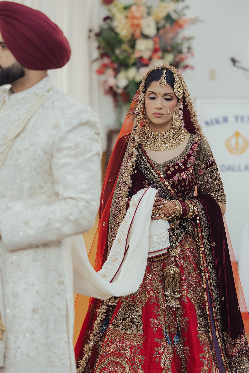 The bride in a deep maroon lehenga during the wedding ceremony