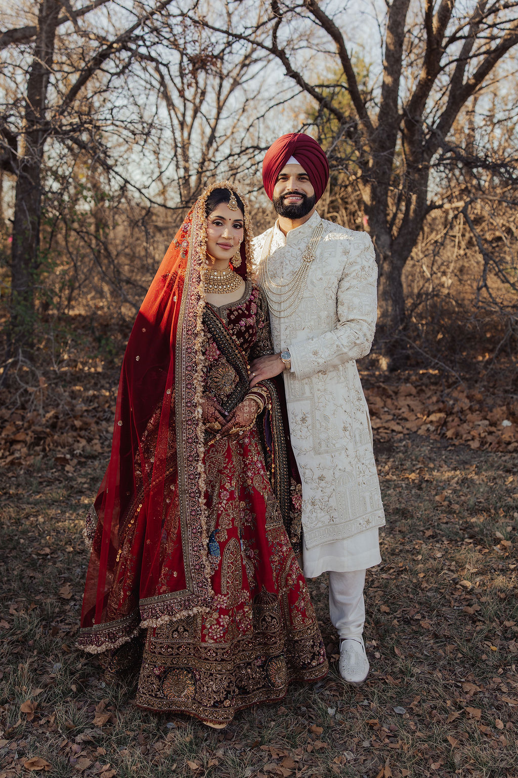 The couple standing together among winter trees
