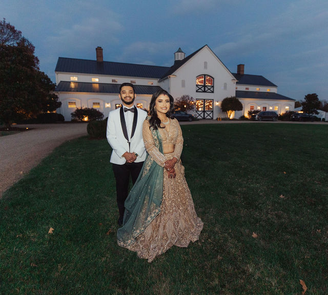 Monali and Sunny in an evening portrait beside the barn