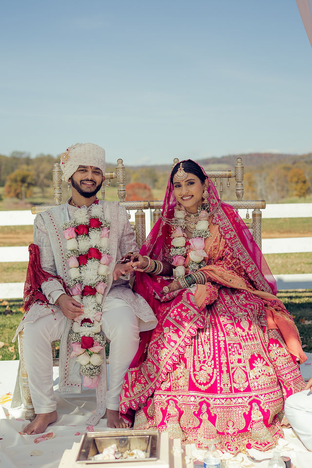 Monali and Sunny seated during the Hindu wedding ceremony