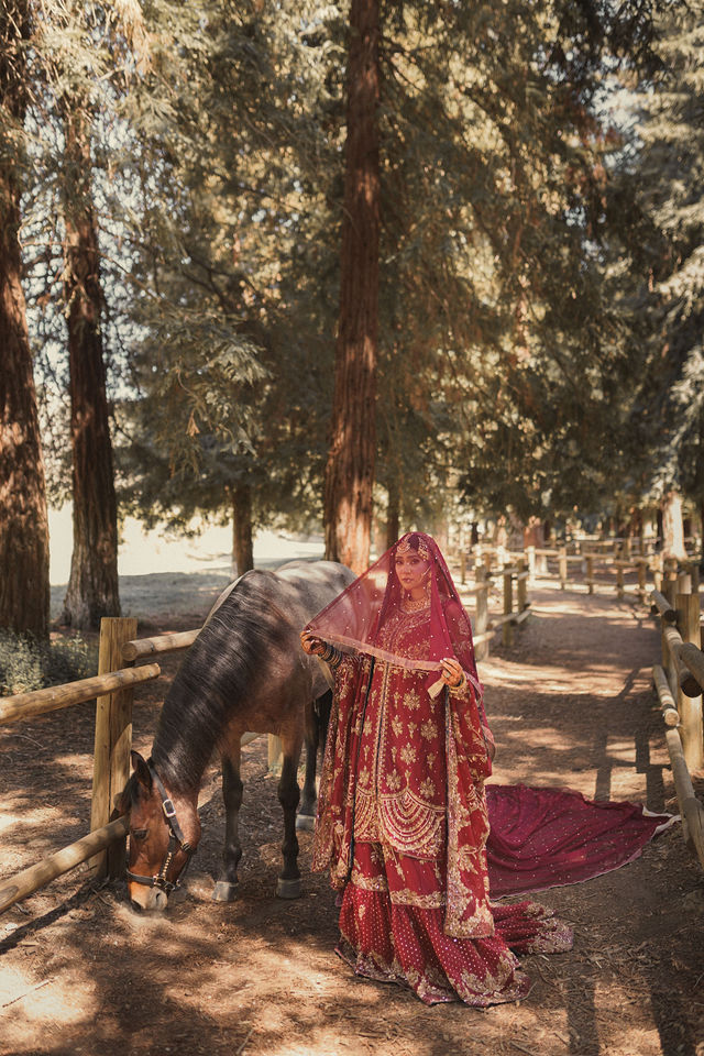 Naba in a garden portrait in red wedding attire