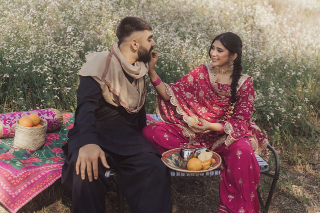 Naba and Ali together in a flower field before the wedding