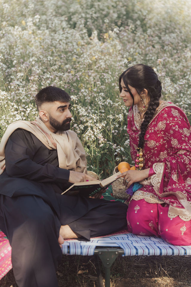 Naba and Ali seated together among flowers