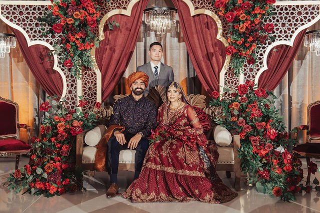 Naba and Ali seated together at their reception