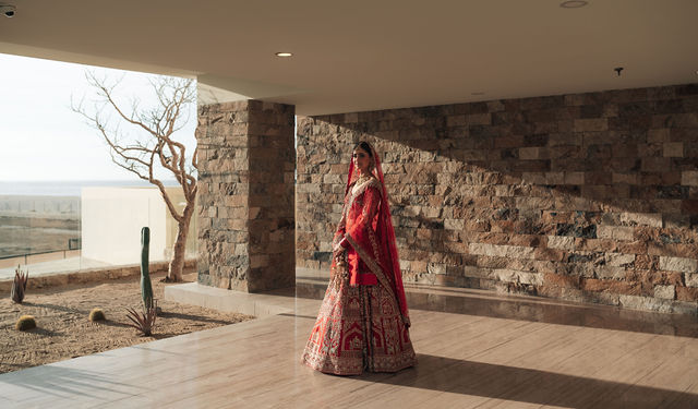 Gureet in a wide bridal portrait against textured stone