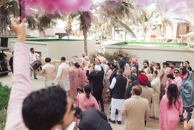 Wedding guests gathered beneath the floral canopy