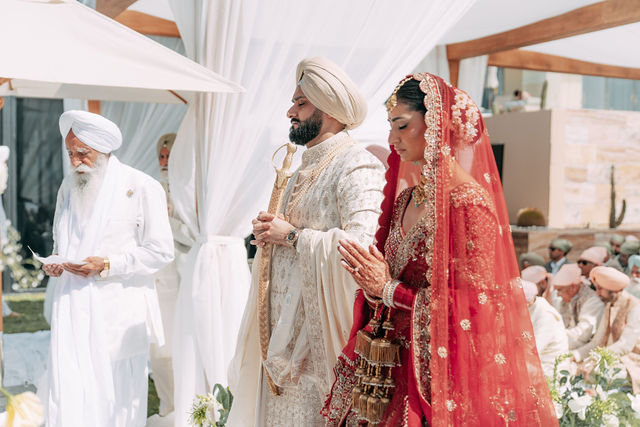 Paul and Gureet walk together beneath the canopy