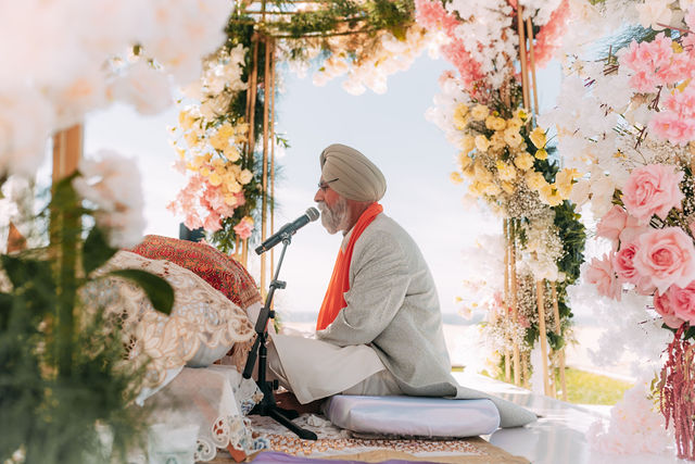 Paul and Gureet seated together during the ceremony
