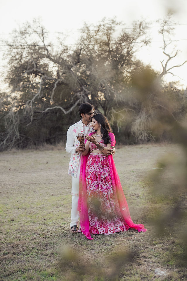 Rachana and Anoop standing close outdoors in their Mehndi attire