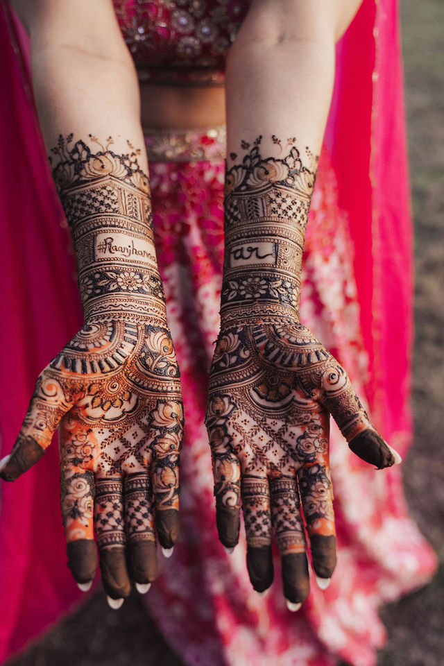 The intricate henna designs across Rachana’s palms and wrists