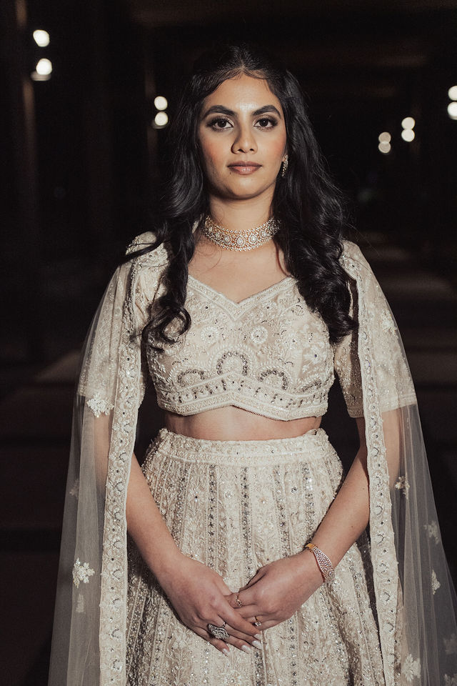 Rachana in her ivory Sangeet ensemble in a softly lit evening portrait
