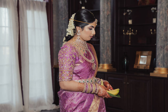 Rachana in her wedding-day sari in warm indoor light